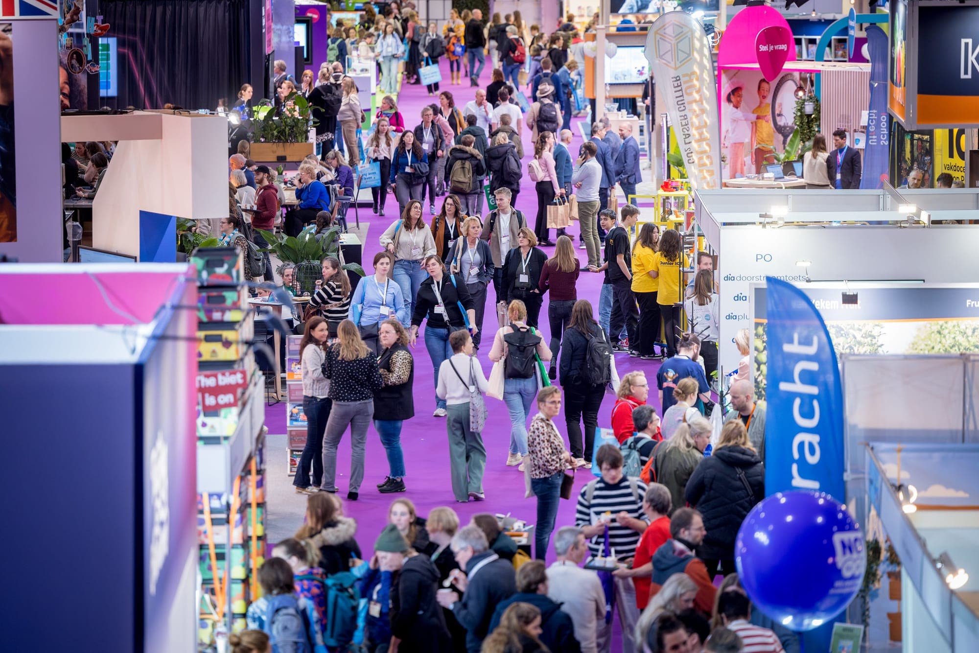 Aerial overview of a busy, colourful trade show floor at Jaarbeurs Utrecht
