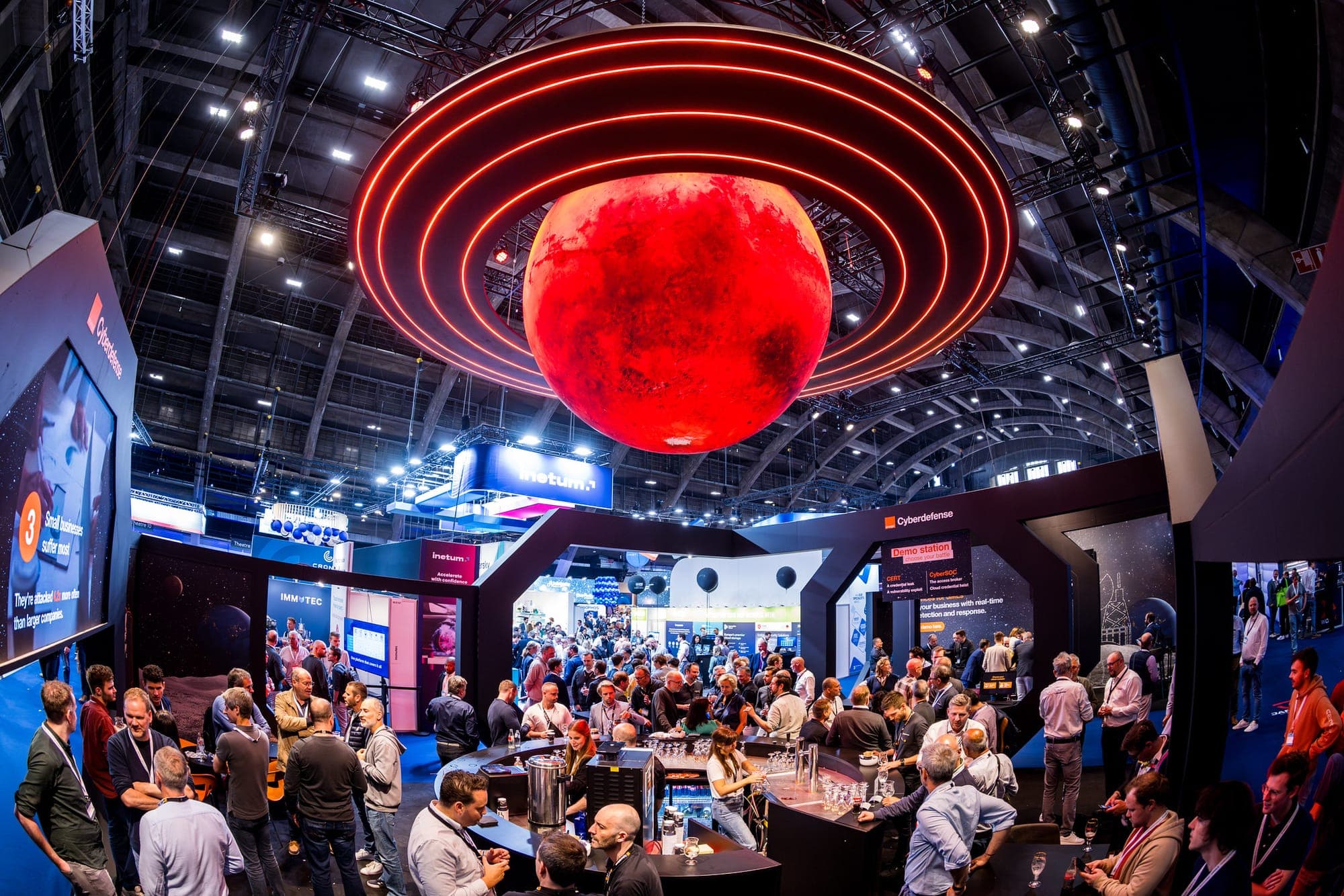Red planet installation with light rings above the show floor of Cybersec Europe at Brussels Expo, TON Media trade show photography
