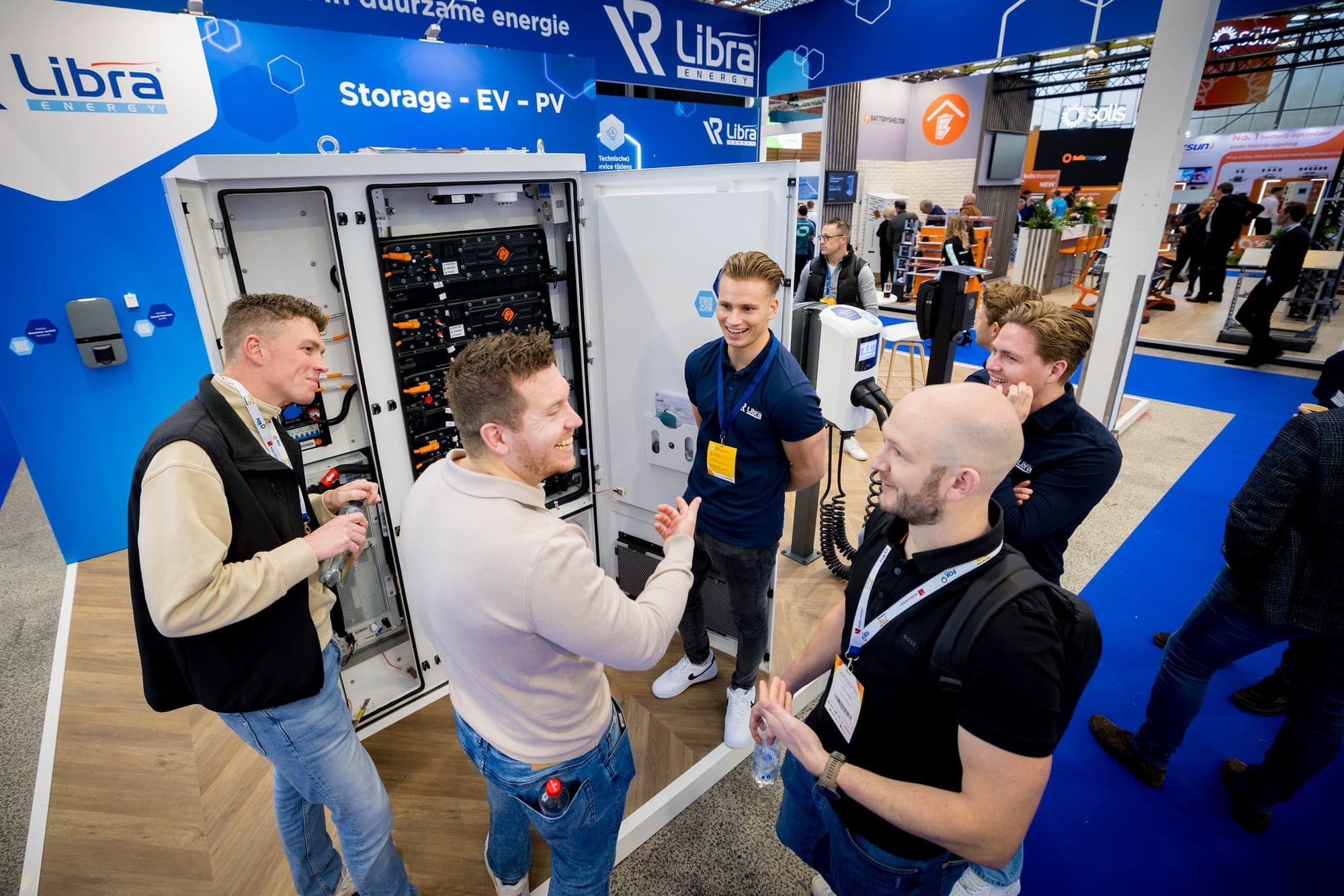 Smiling professionals at an energy stand at a trade fair