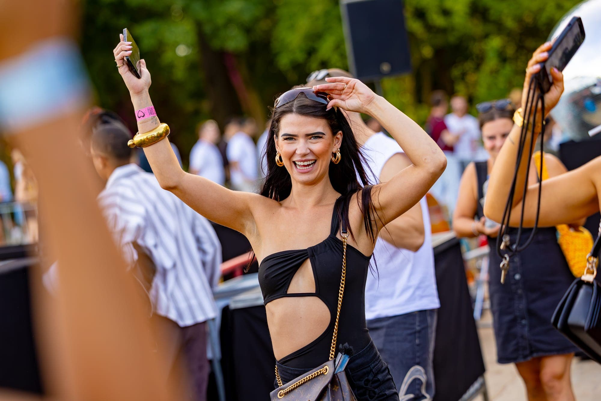 Dancing visitor with raised hands at LoveLand Festival in Sloterpark Amsterdam